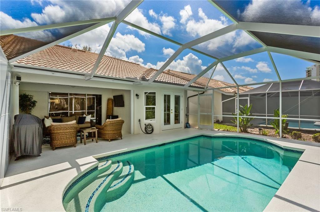 754 Wiggins Bay Drive Naples, FL 34110 - Photo 24 of 34 a view of a patio with table and chairs potted plants with wooden floor
