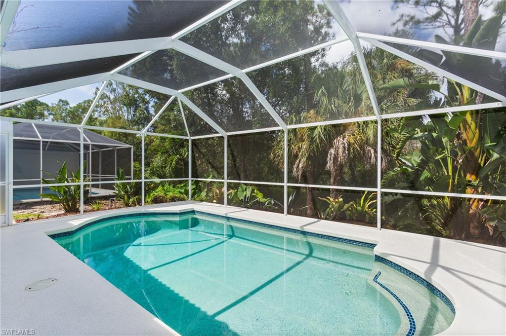 754 Wiggins Bay Drive Naples, FL 34110 - Photo 26 of 34 a view of a backyard with a swimming pool