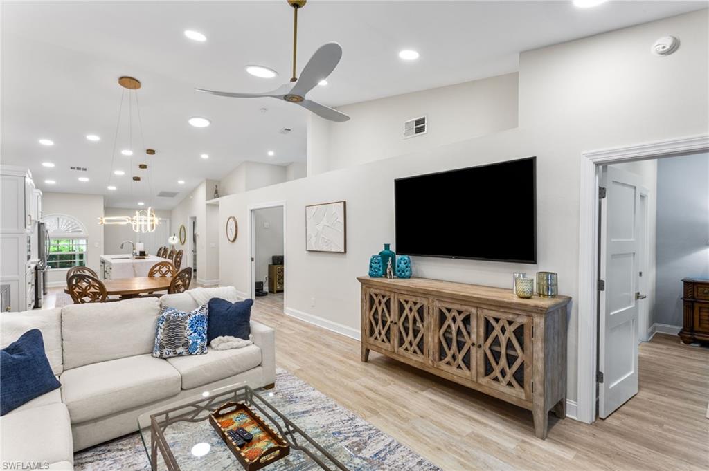 754 Wiggins Bay Drive Naples, FL 34110 - Photo 9 of 34 a living room with furniture and a flat screen tv