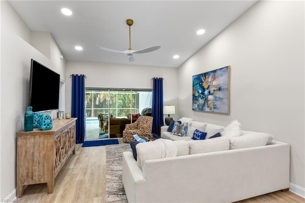 754 Wiggins Bay Drive Naples, FL 34110 - Photo 10 of 34 a living room with furniture and a flat screen tv