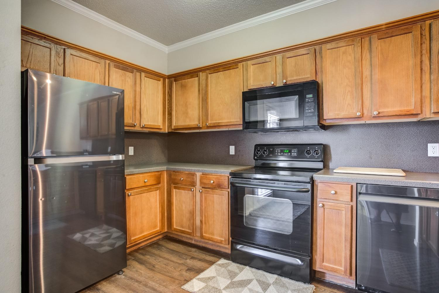 2101 Main Street, Unit 2 Lubbock, TX 79401 - Photo 12 of 31 a kitchen with stainless steel appliances granite countertop a refrigerator stove and sink