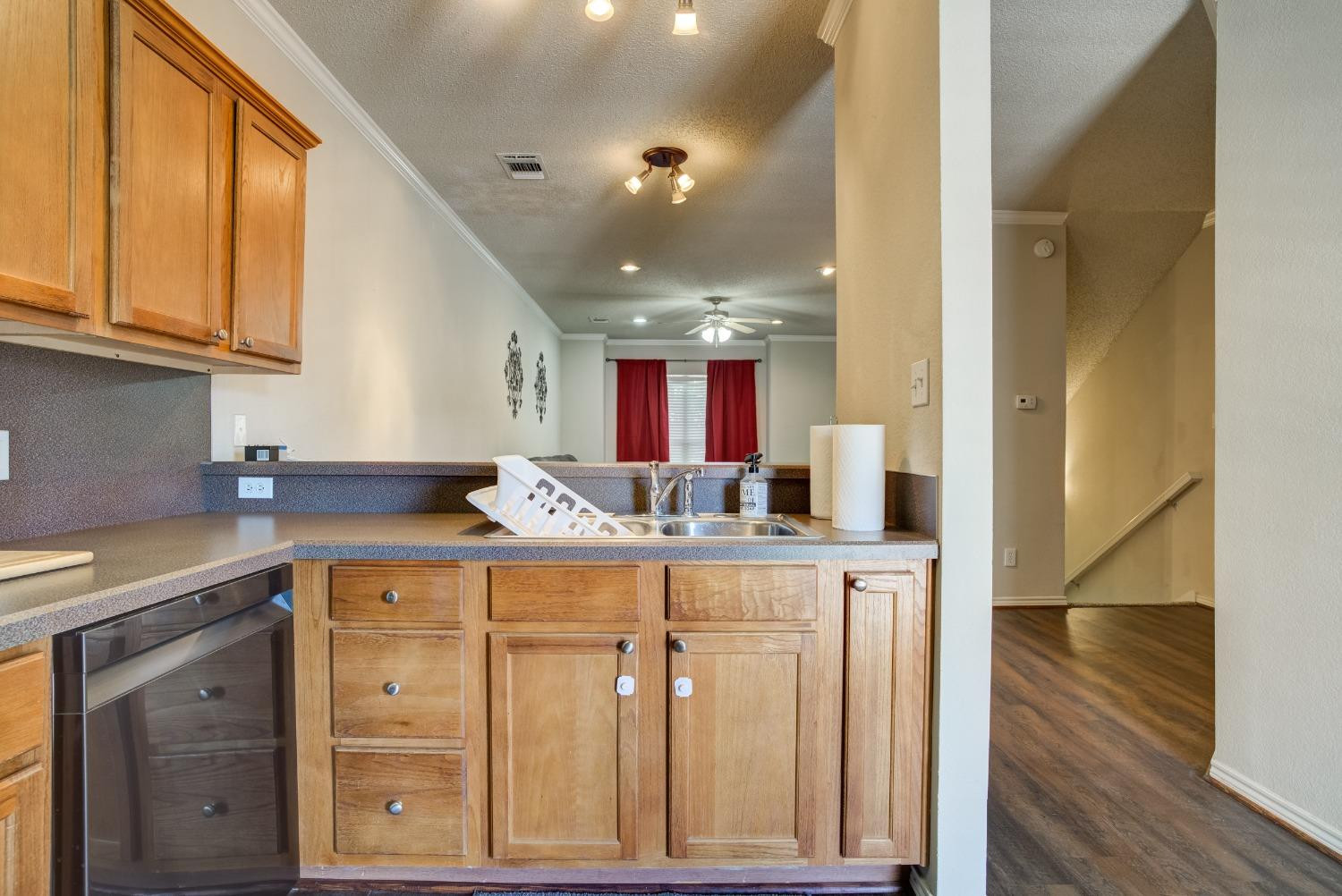 2101 Main Street, Unit 2 Lubbock, TX 79401 - Photo 15 of 31 a kitchen with stainless steel appliances granite countertop a sink and cabinets with wooden floor