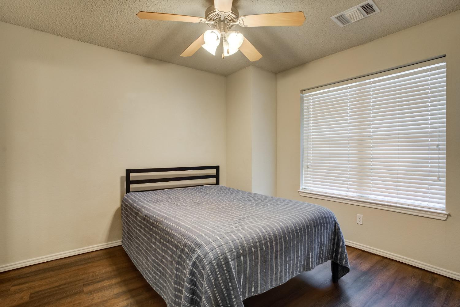 2101 Main Street, Unit 2 Lubbock, TX 79401 - Photo 16 of 31 a bedroom with a bed and a window