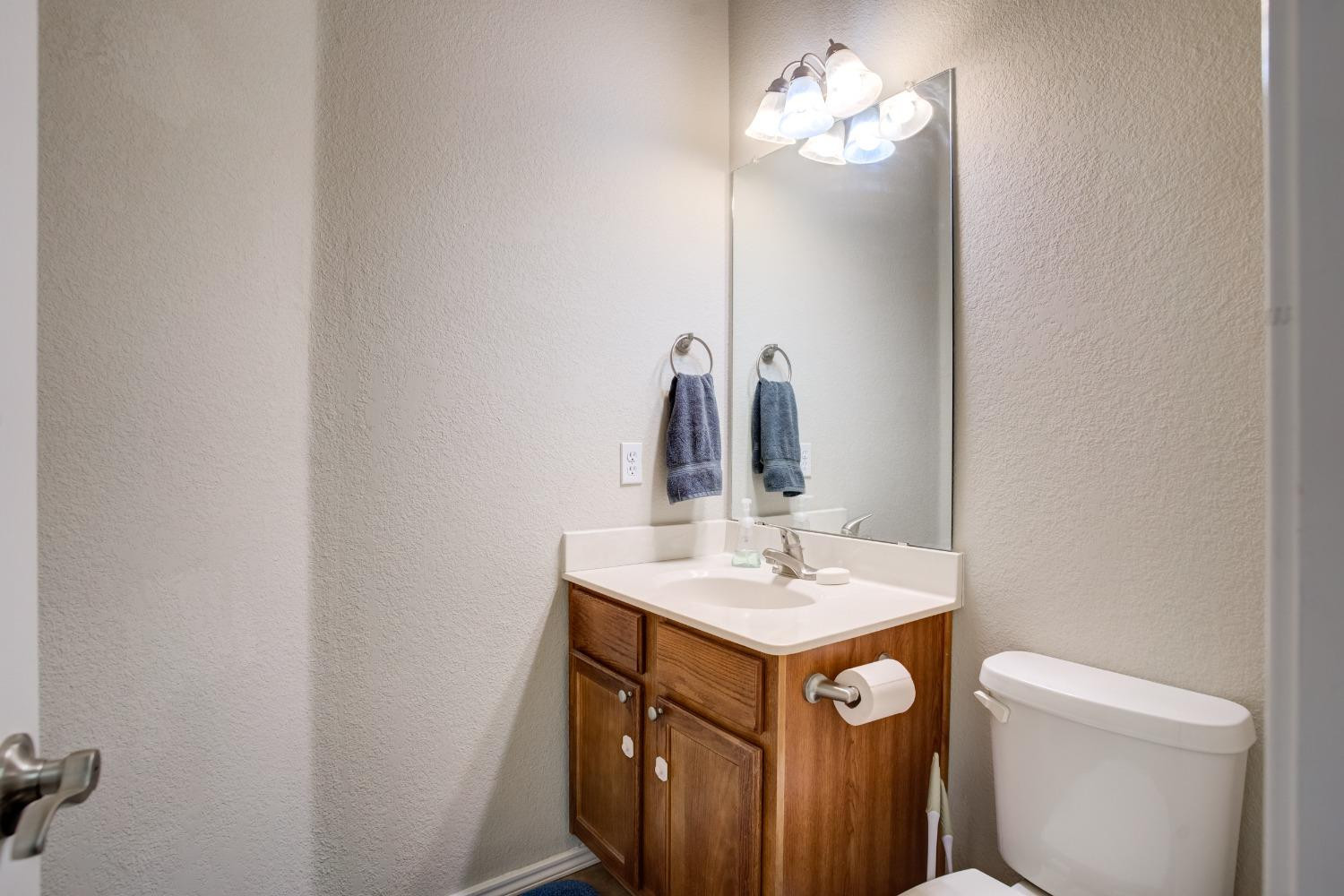 2101 Main Street, Unit 2 Lubbock, TX 79401 - Photo 20 of 31 a bathroom with a sink vanity and a mirror