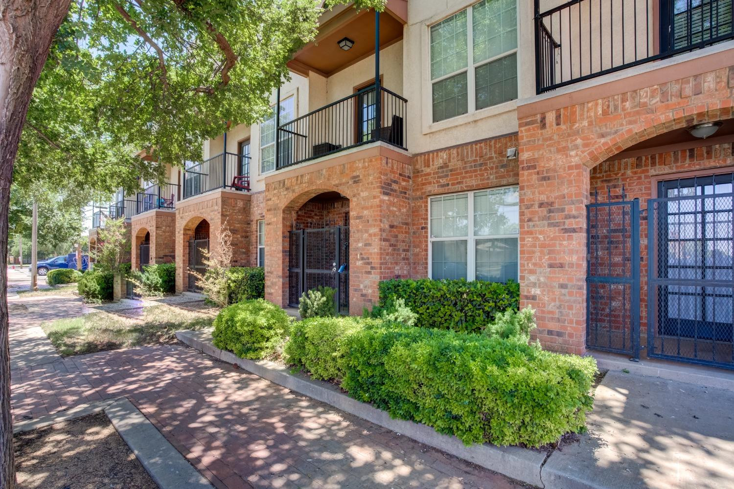 2101 Main Street, Unit 2 Lubbock, TX 79401 - Photo 2 of 31 front view of a brick house with a yard