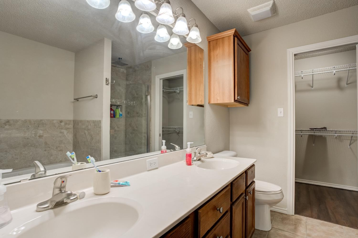2101 Main Street, Unit 2 Lubbock, TX 79401 - Photo 26 of 31 a bathroom with a sink and a mirror