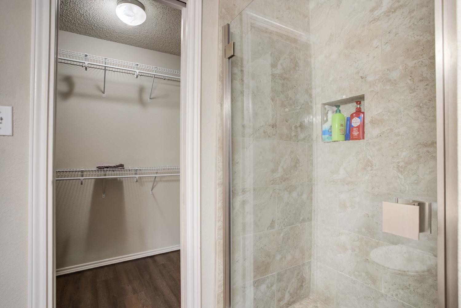 2101 Main Street, Unit 2 Lubbock, TX 79401 - Photo 27 of 31 a bathroom with a glass shower door