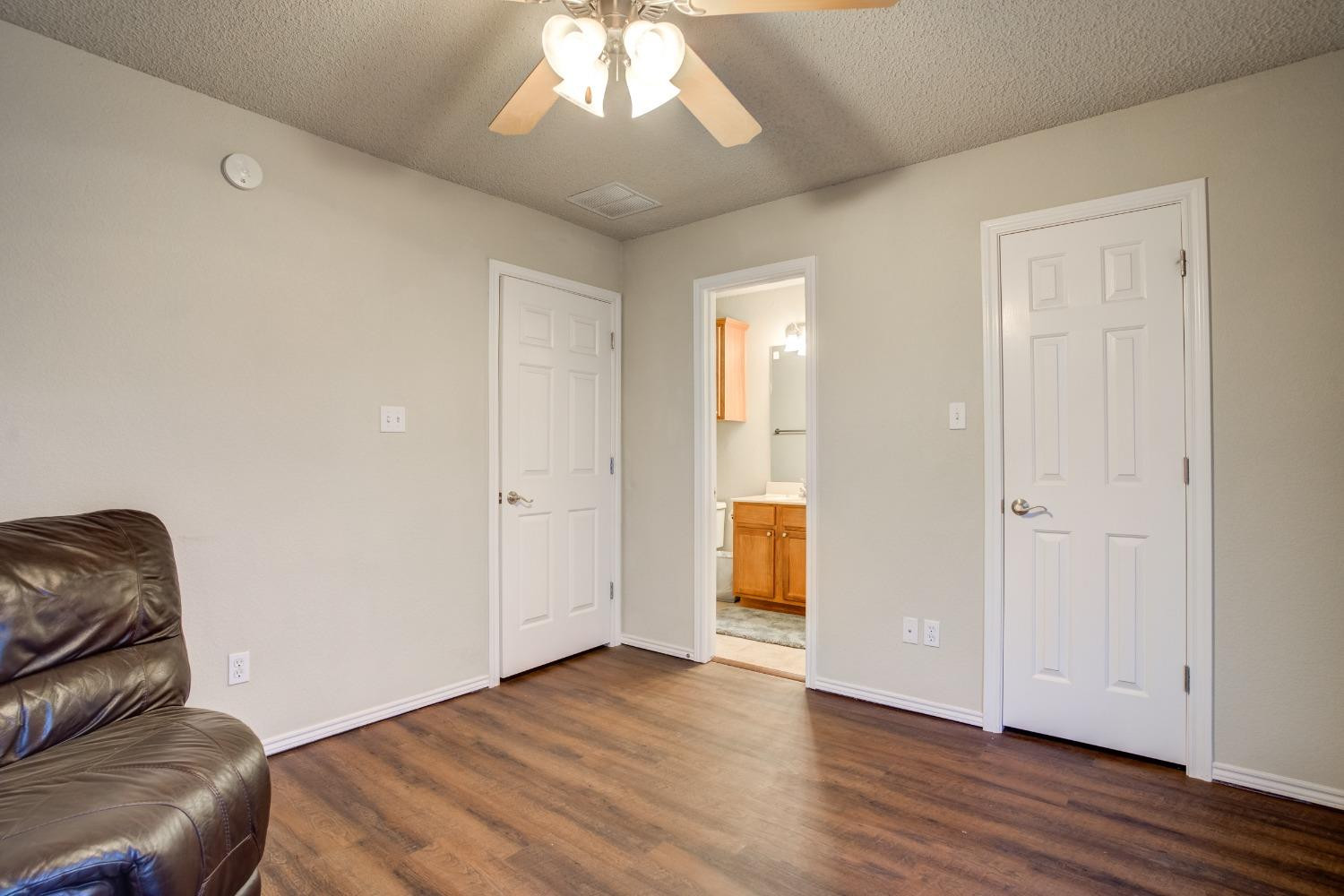 2101 Main Street, Unit 2 Lubbock, TX 79401 - Photo 29 of 31 a living room with furniture and a chandelier
