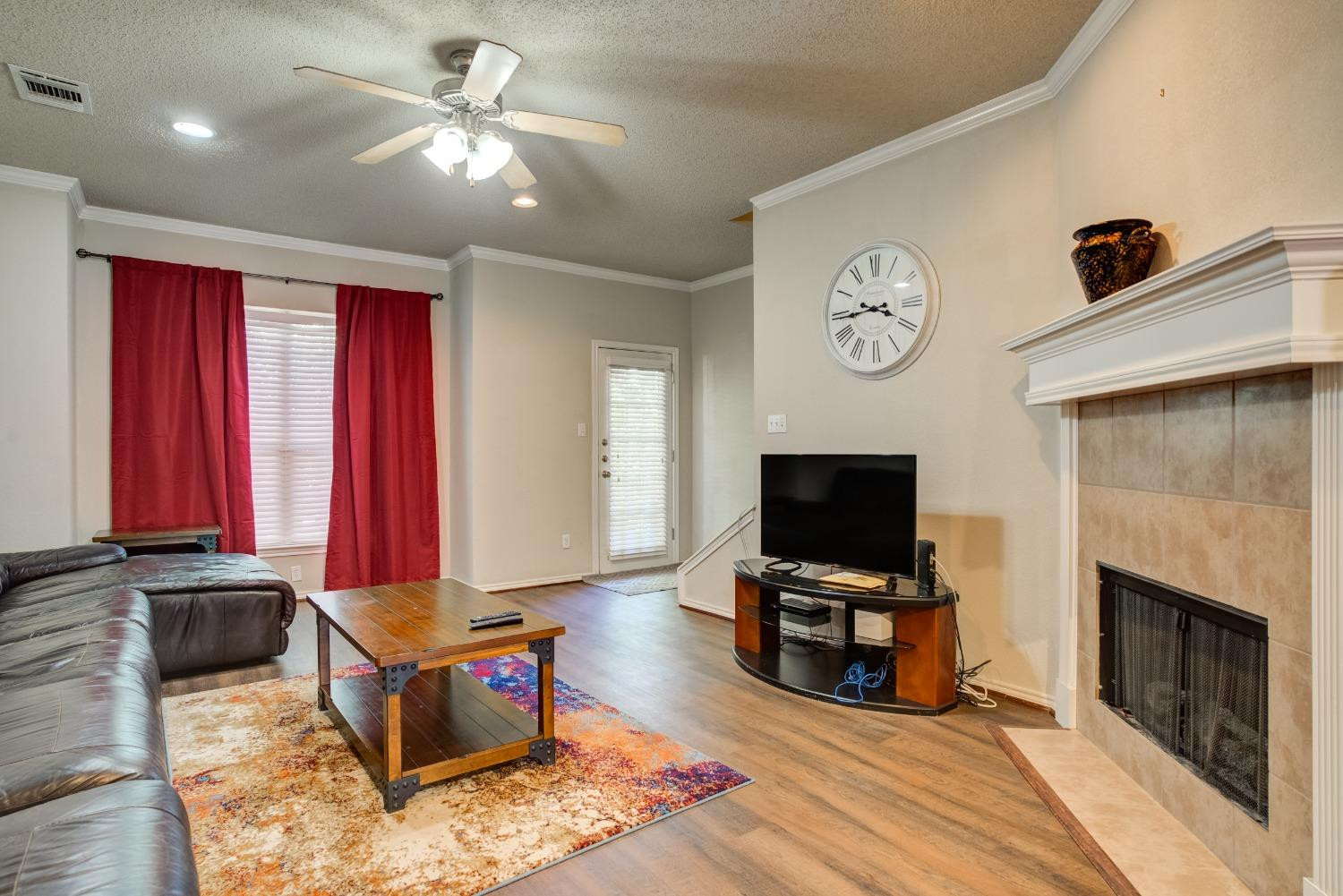 2101 Main Street, Unit 2 Lubbock, TX 79401 - Photo 6 of 31 a living room with furniture and a flat screen tv