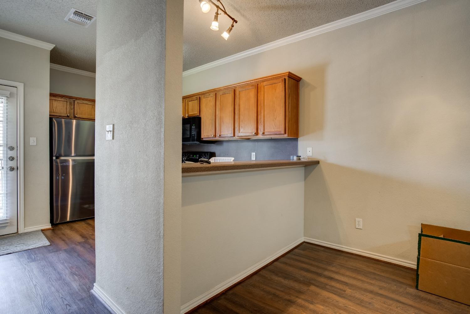 2101 Main Street, Unit 2 Lubbock, TX 79401 - Photo 10 of 31 a view of a kitchen with wooden floor and a window