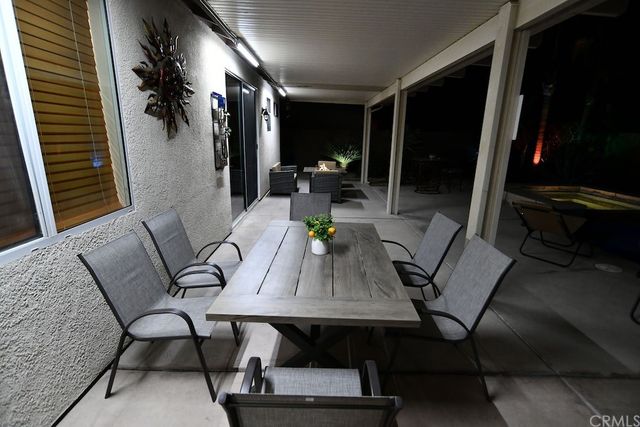 a room with pool table and chairs