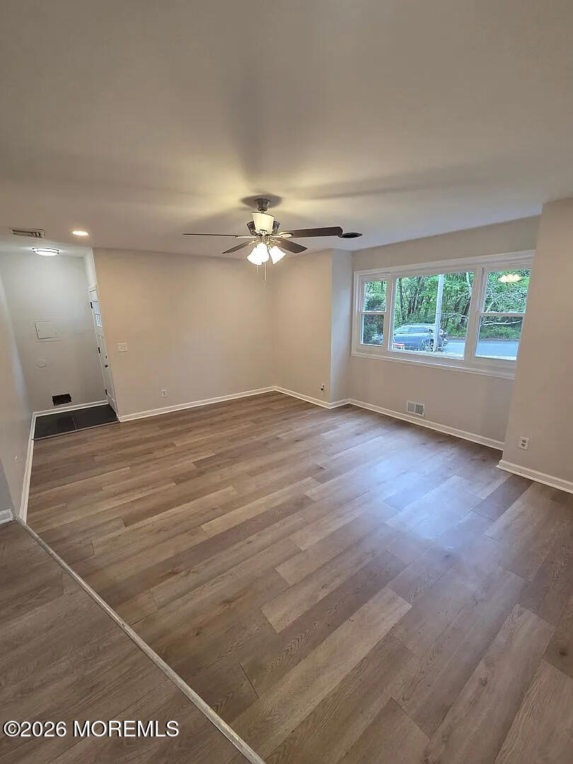 3 Freewood Street Howell, NJ 07731 - Photo 4 of 9 an empty room with wooden floor and windows