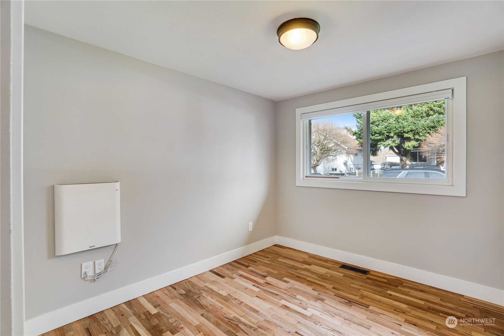 1209 South Donovan Street Seattle, WA 98108 - Photo 15 of 19 a view of room with window and wooden floor