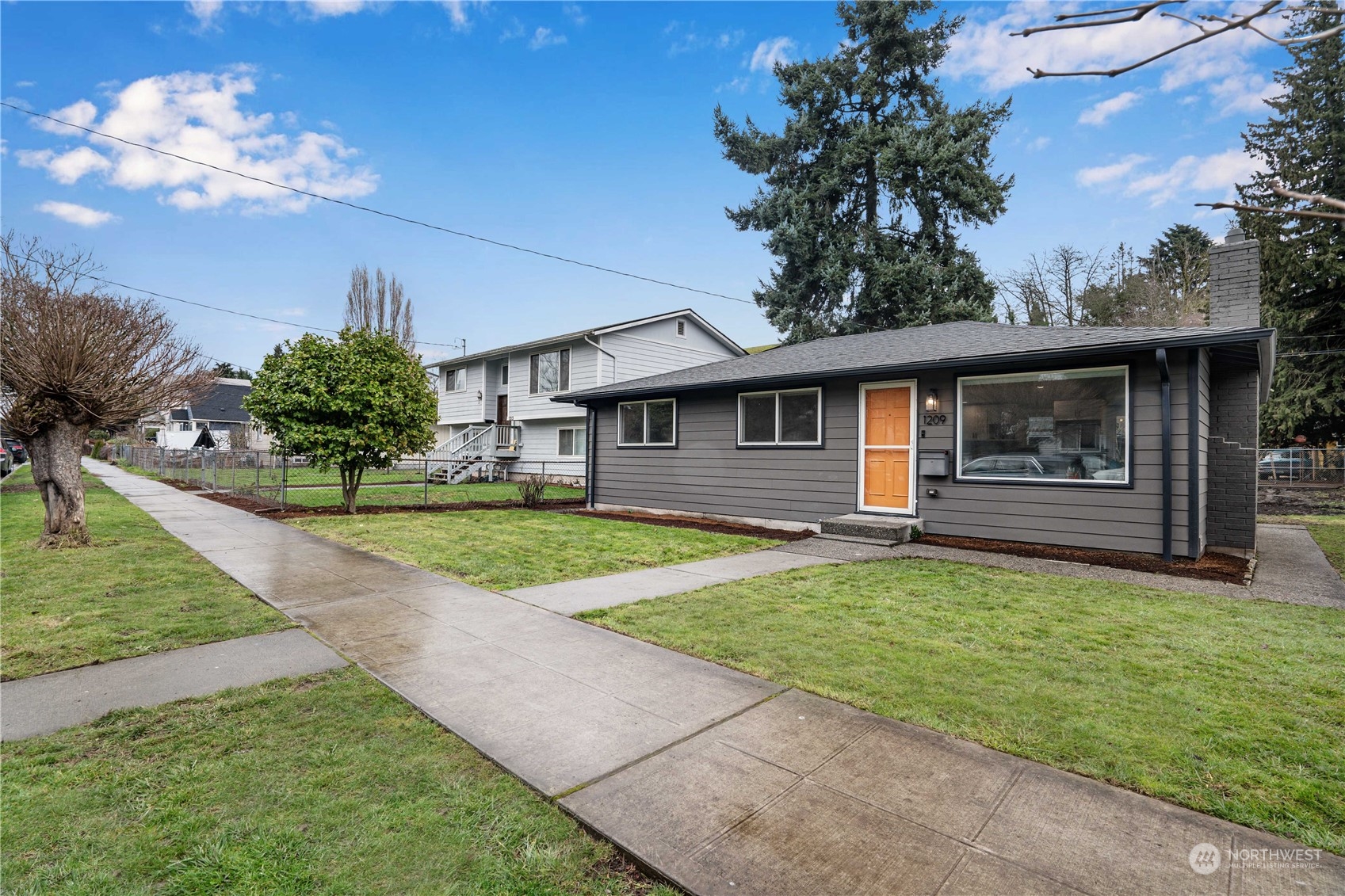 1209 South Donovan Street Seattle, WA 98108 - Photo 2 of 19 a view of a house with backyard and a garden