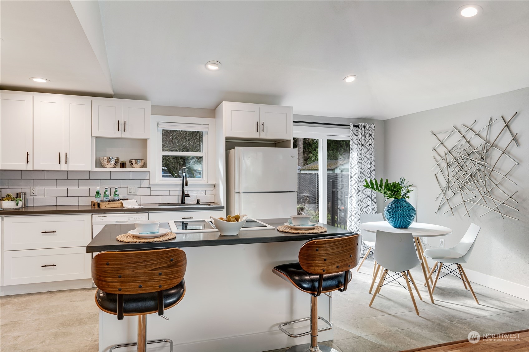 1209 South Donovan Street Seattle, WA 98108 - Photo 6 of 19 a kitchen with stainless steel appliances granite countertop a counter space a sink cabinets and a window