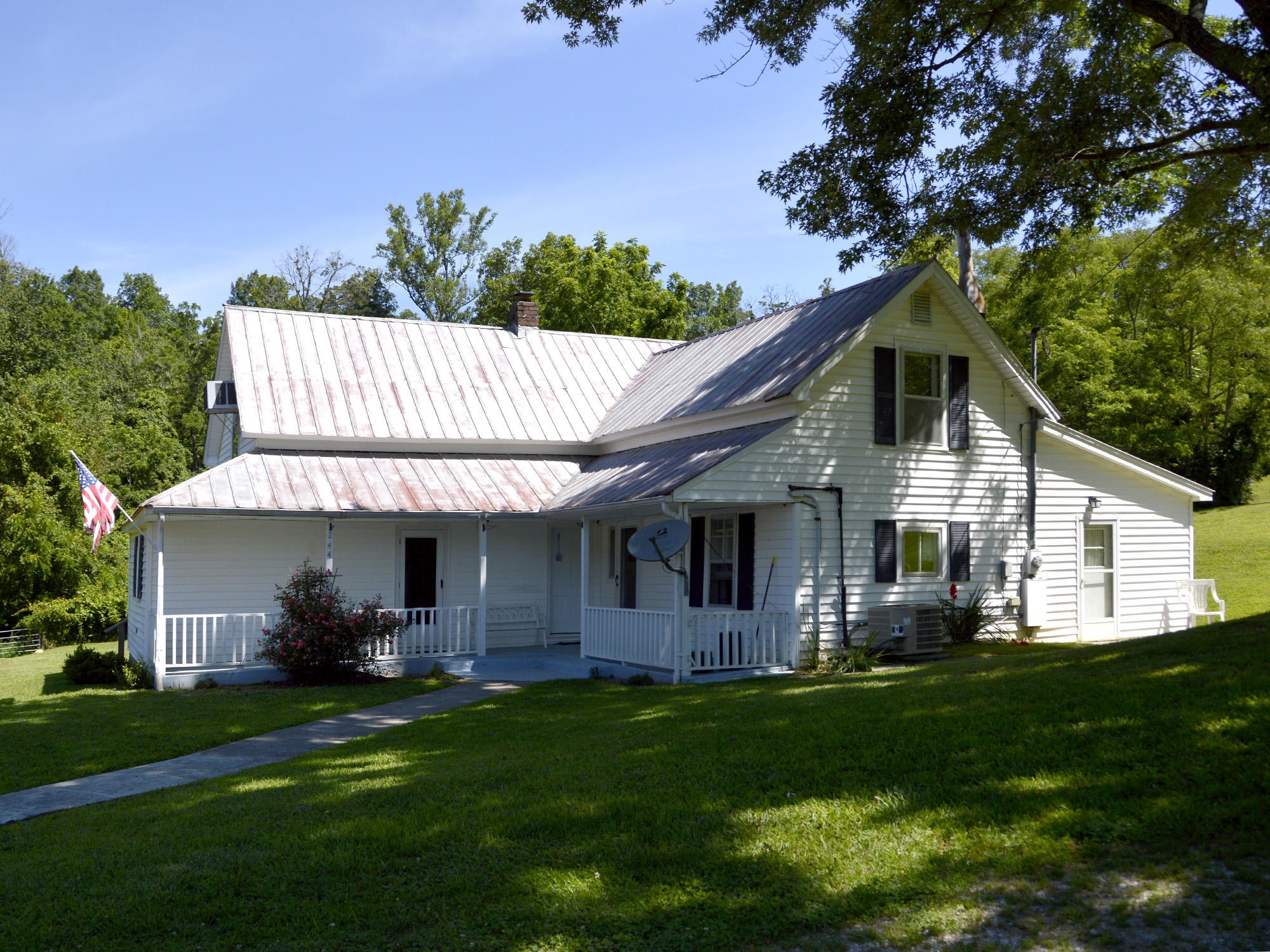 244 Sallings Road Luttrell, TN 37779 - Photo 1 of 19 a front view of a house with a garden and plants