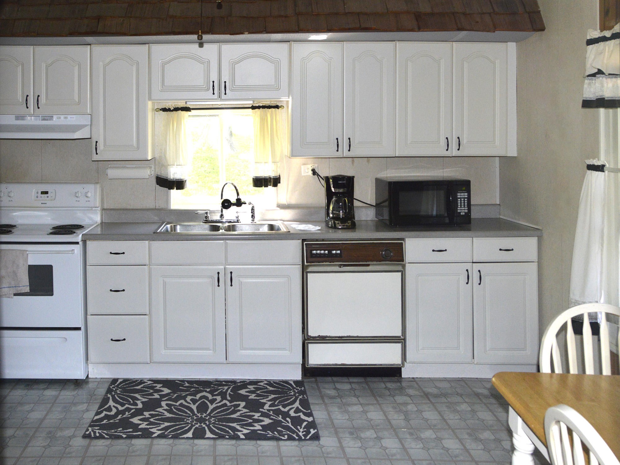 244 Sallings Road Luttrell, TN 37779 - Photo 6 of 19 a kitchen with white cabinets and white appliances