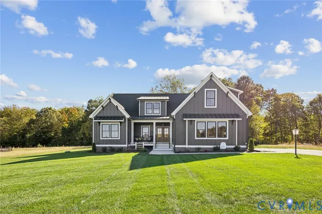 a front view of a house with a garden and porch