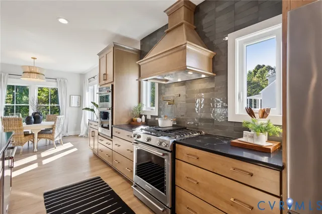 a kitchen with stainless steel appliances granite countertop a stove and a refrigerator
