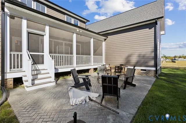 a view of a patio with dining table and chairs