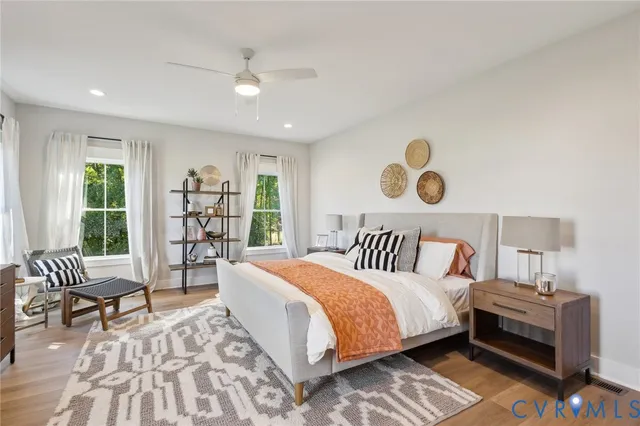 a large bedroom with a bed and large windows