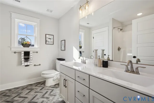 a spacious bedroom with a bed a table and chair