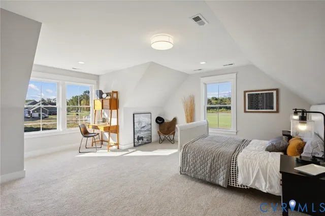 a front view of a house with a garden and yard