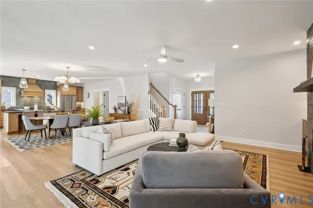 a living room with furniture and a view of kitchen