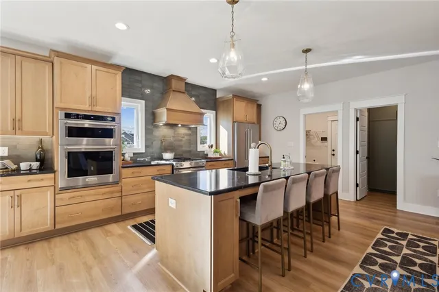 a large kitchen with a table and chairs