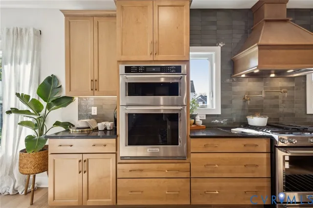 a kitchen with appliances a stove and cabinets