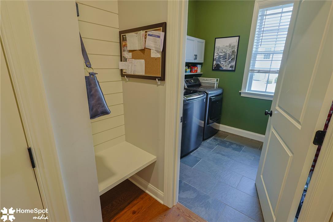 4518 Old Saucon Road Bethlehem, PA 18015 - Photo 7 of 19 A well-appointed laundry area offers convenient household utility, featuring modern appliances and a practical built-in bench.