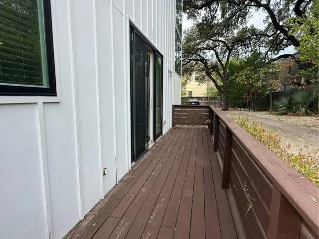 a view of balcony with wooden floor