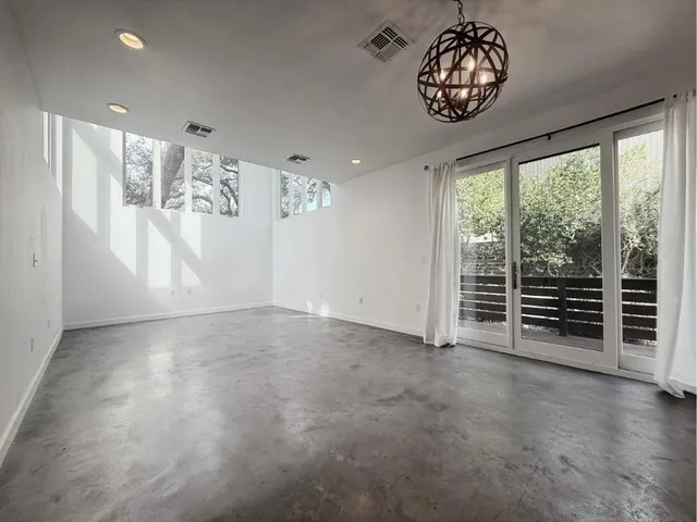 a kitchen with stainless steel appliances granite countertop a stove a refrigerator a sink and white cabinets