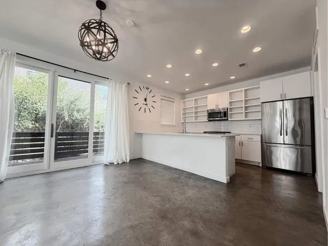 a view of wooden floor and windows in a room