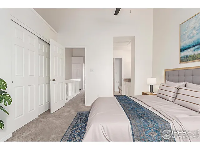 a bedroom with a bed and a painting