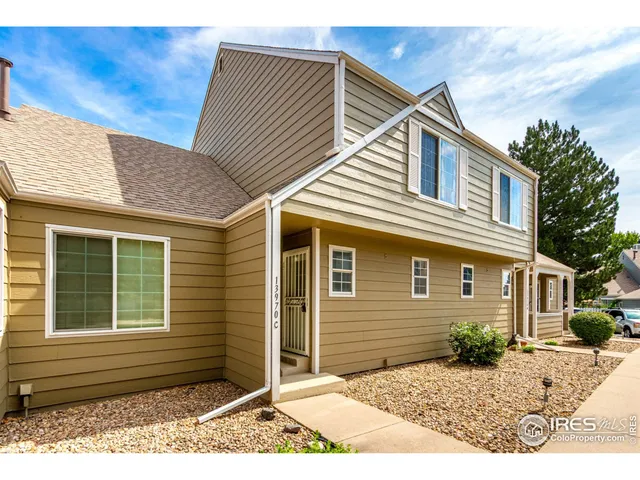 a view of a house with wooden fence