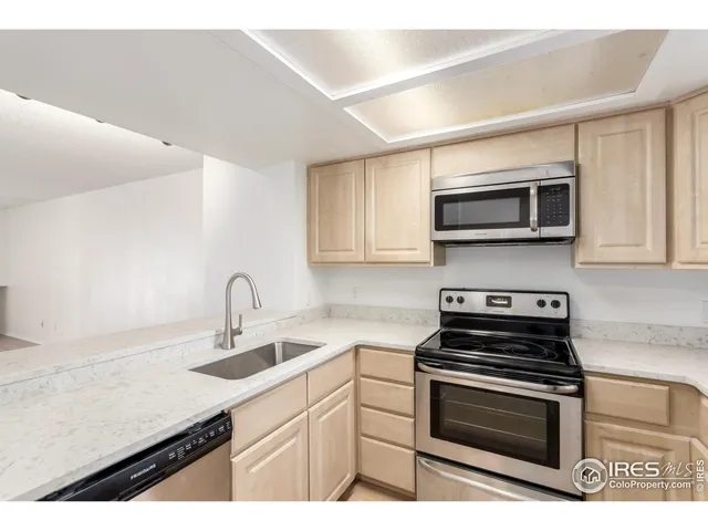 a kitchen with kitchen island a sink stainless steel appliances and cabinets