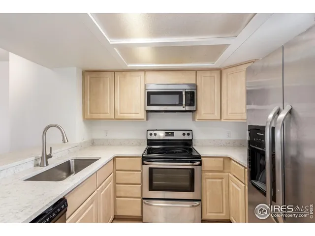 a kitchen with kitchen island a sink stainless steel appliances and cabinets