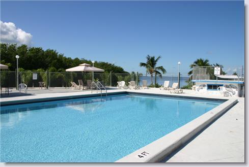325 Calusa Street, Unit 476 Key Largo, FL 33037 - Photo 2 of 3 a view of a swimming pool with an outdoor seating