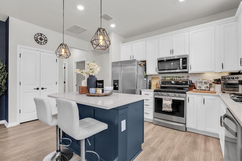 6352 Mooring Line Circle Apollo Beach, FL 33572 - Photo 7 of 33 a kitchen with a refrigerator a stove cabinets dining table and chairs