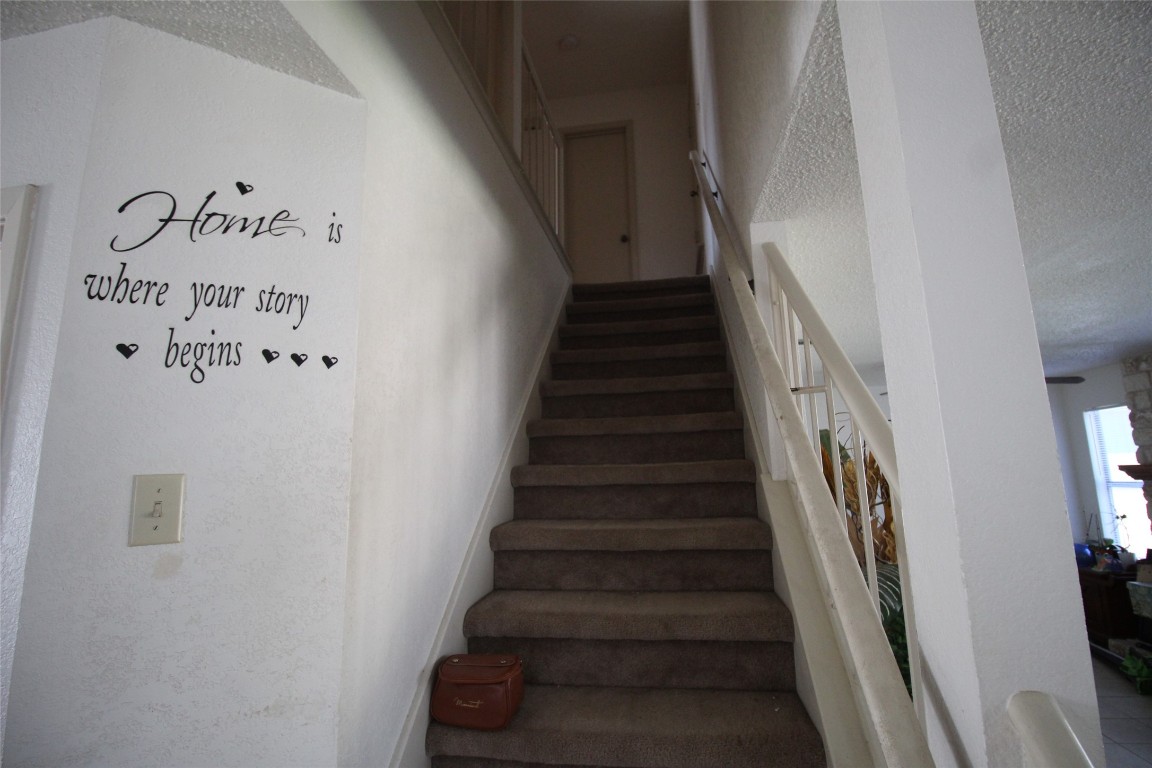 808 Angleton Cove Austin, TX 78748 - Photo 8 of 17 Staircase with a textured ceiling