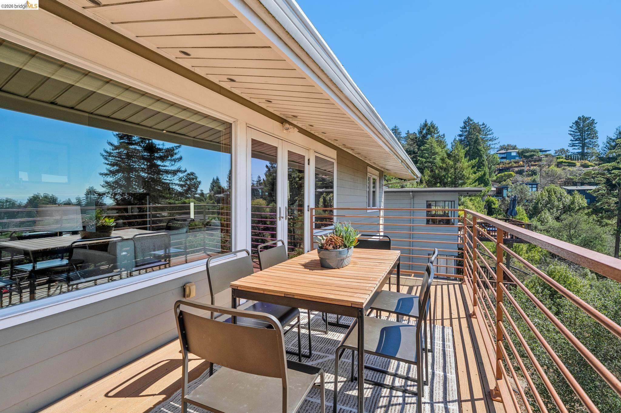 1394 Queens Road Berkeley, CA 94708 - Photo 21 of 63 Expansive deck featuring wood-finish flooring, white double doors, a large picture window, and horizontal metal railings