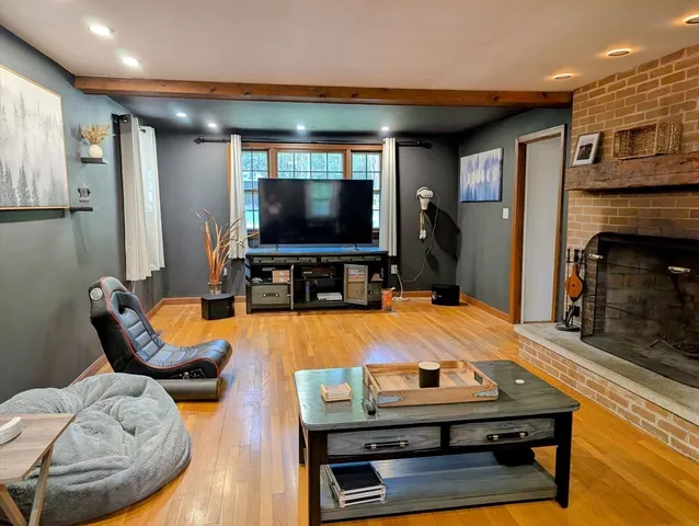 a open kitchen view with fireplace and wooden floor