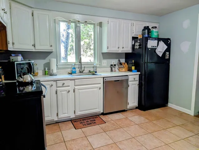 a kitchen with a sink cabinets and window