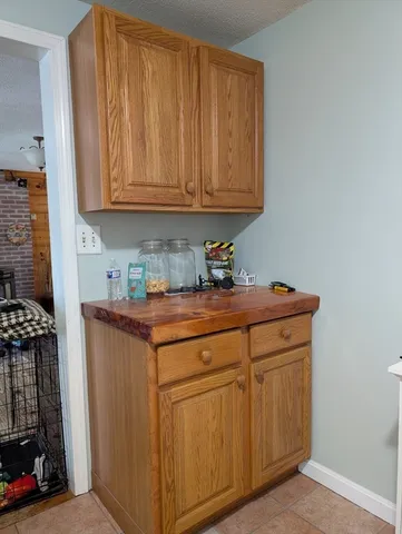 a utility room with granite countertop cabinets washer and dryer
