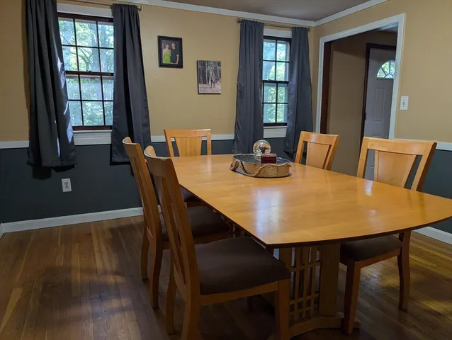 a view of a dining room with furniture and window