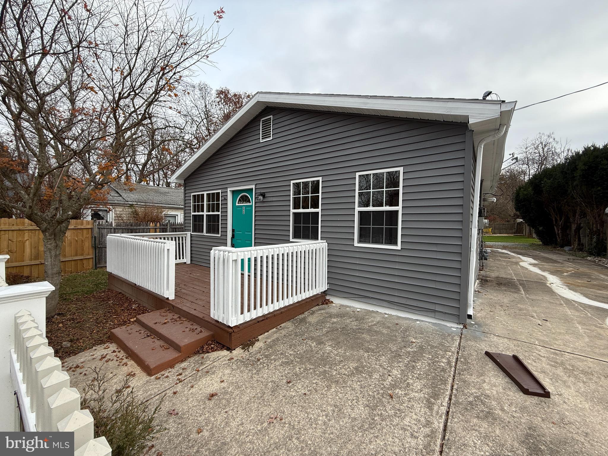 a view of a house with a yard next to a road