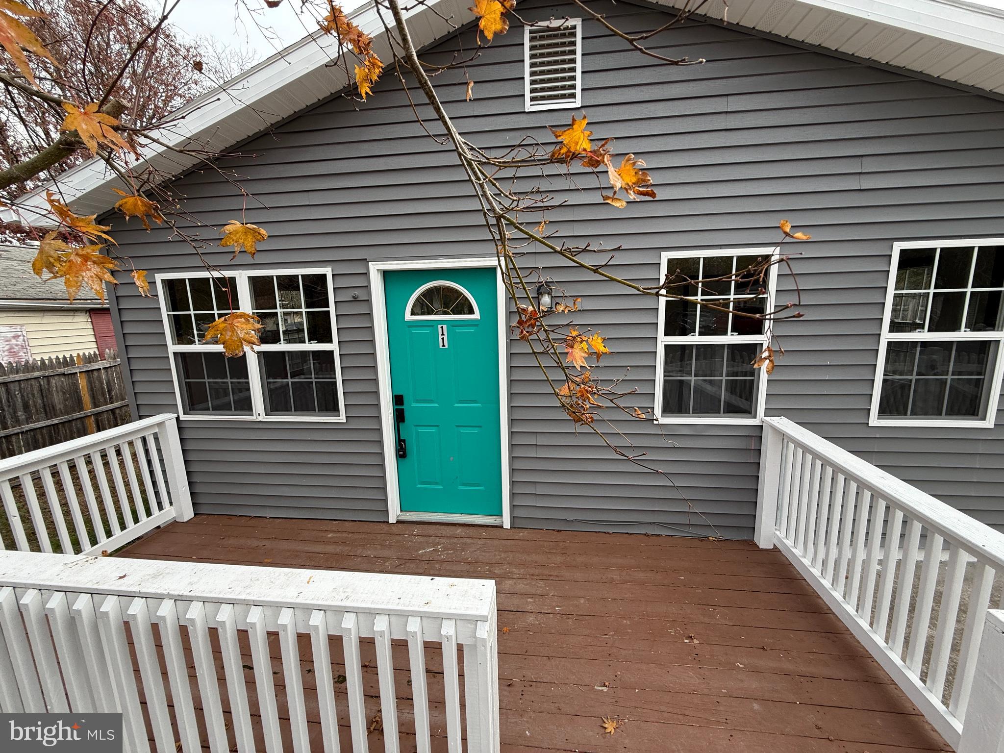 11 Sunset Lane Bridgeton, NJ 08302 - Photo 2 of 16 a front view of a house with a large window