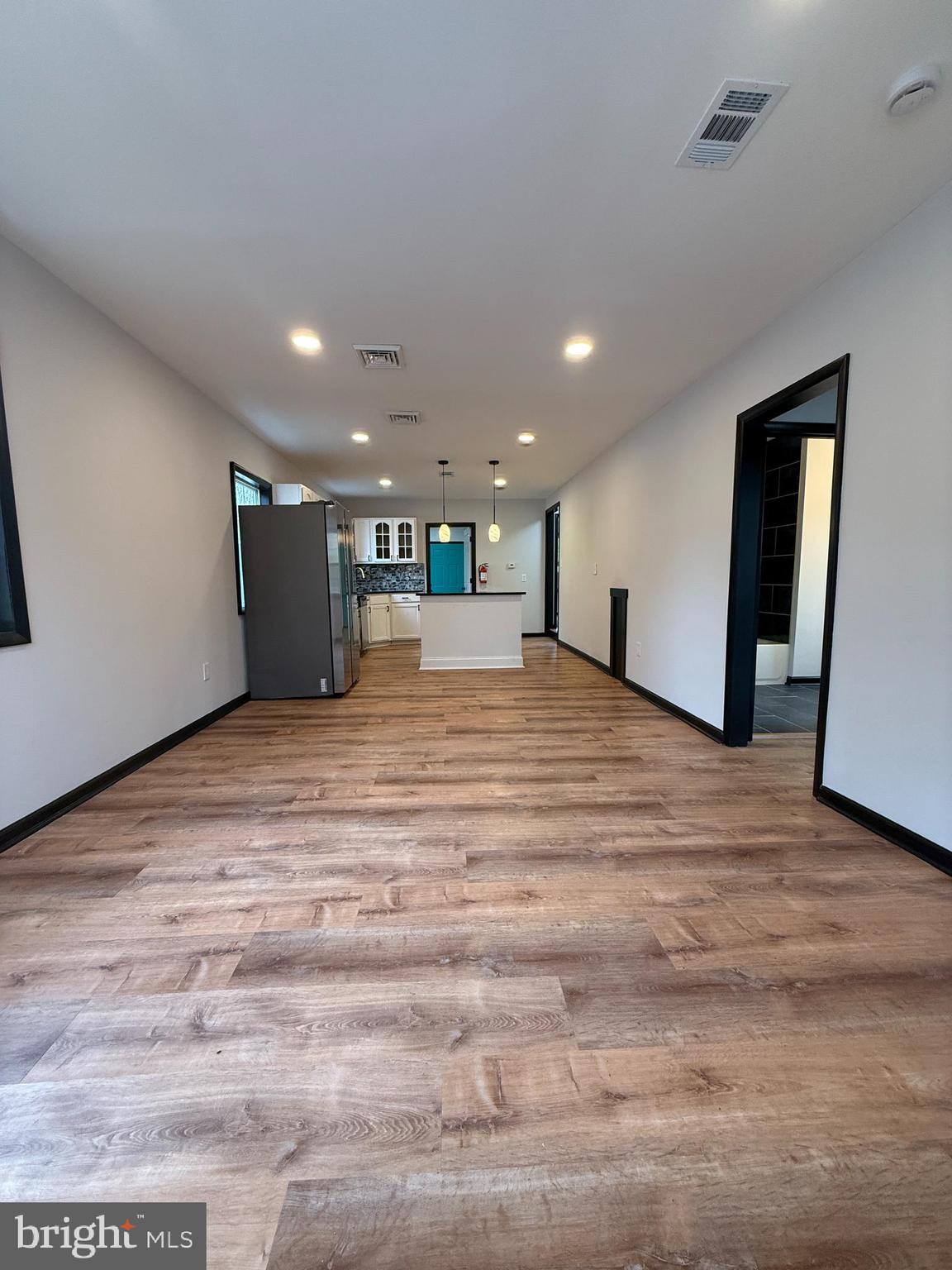 11 Sunset Lane Bridgeton, NJ 08302 - Photo 3 of 16 a view of an empty room with wooden floor and a window