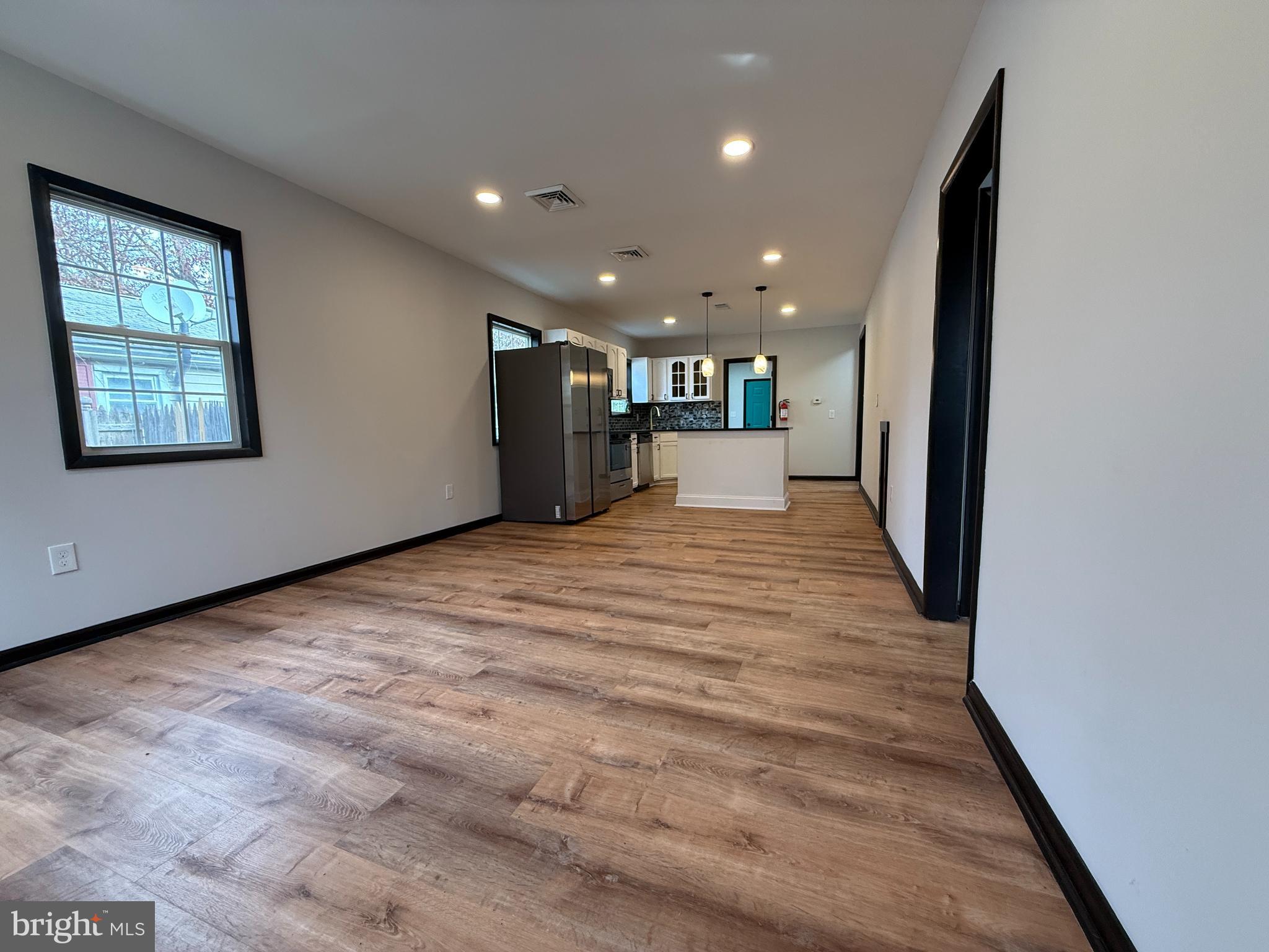 11 Sunset Lane Bridgeton, NJ 08302 - Photo 4 of 16 a view of an empty room with kitchen and window
